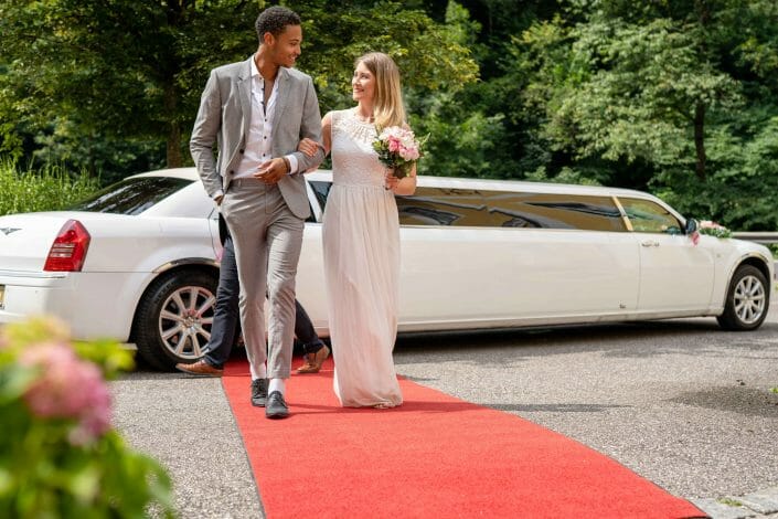 bridal couple with limousine