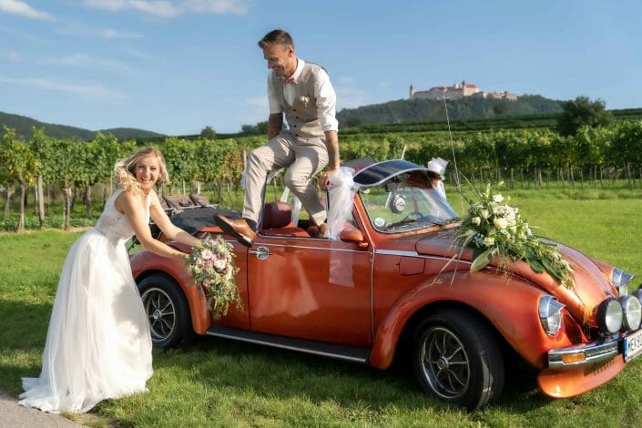 bridal couple in vw beetle